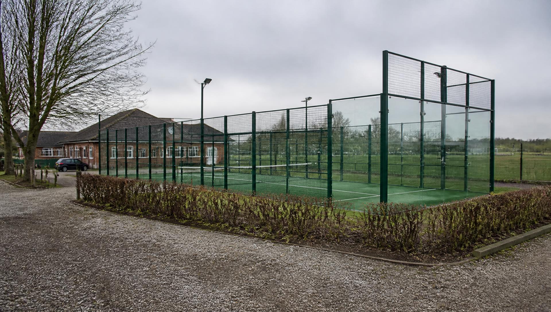 Newly built outdoor padel court on the edge of a rural UK sports club ground